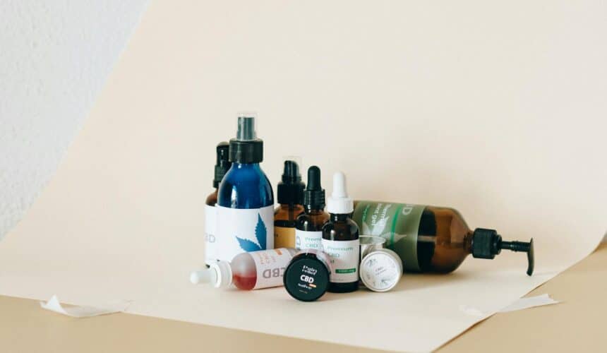 A collection of CBD products including oils and sprays in a studio setup with neutral background.