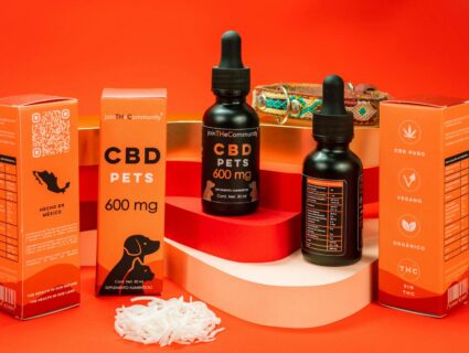 CBD pet product display with colorful packaging and a bold red backdrop.